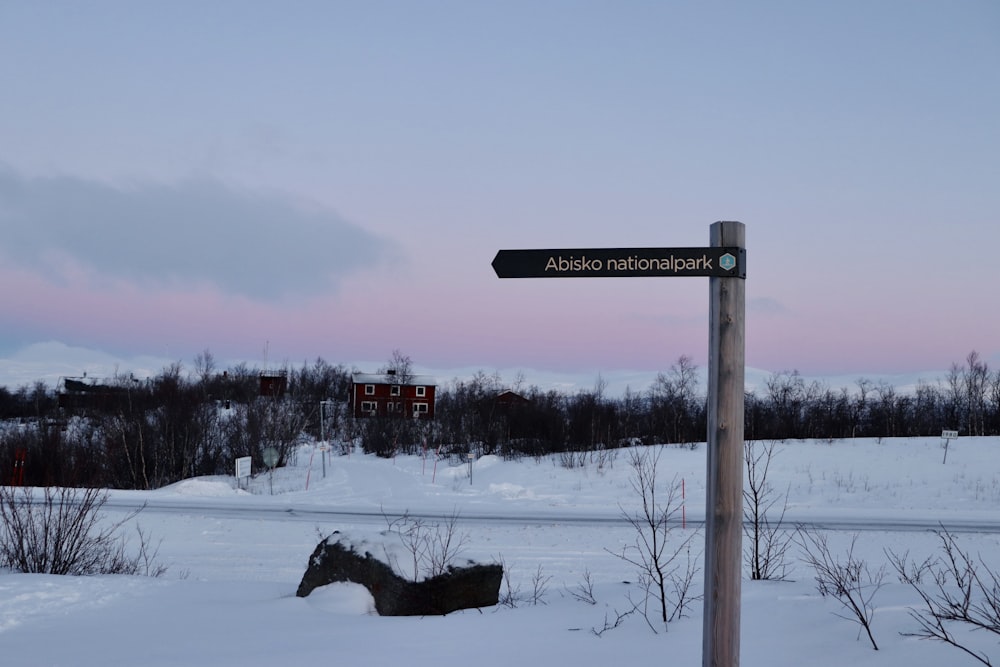 a sign in a snowy field