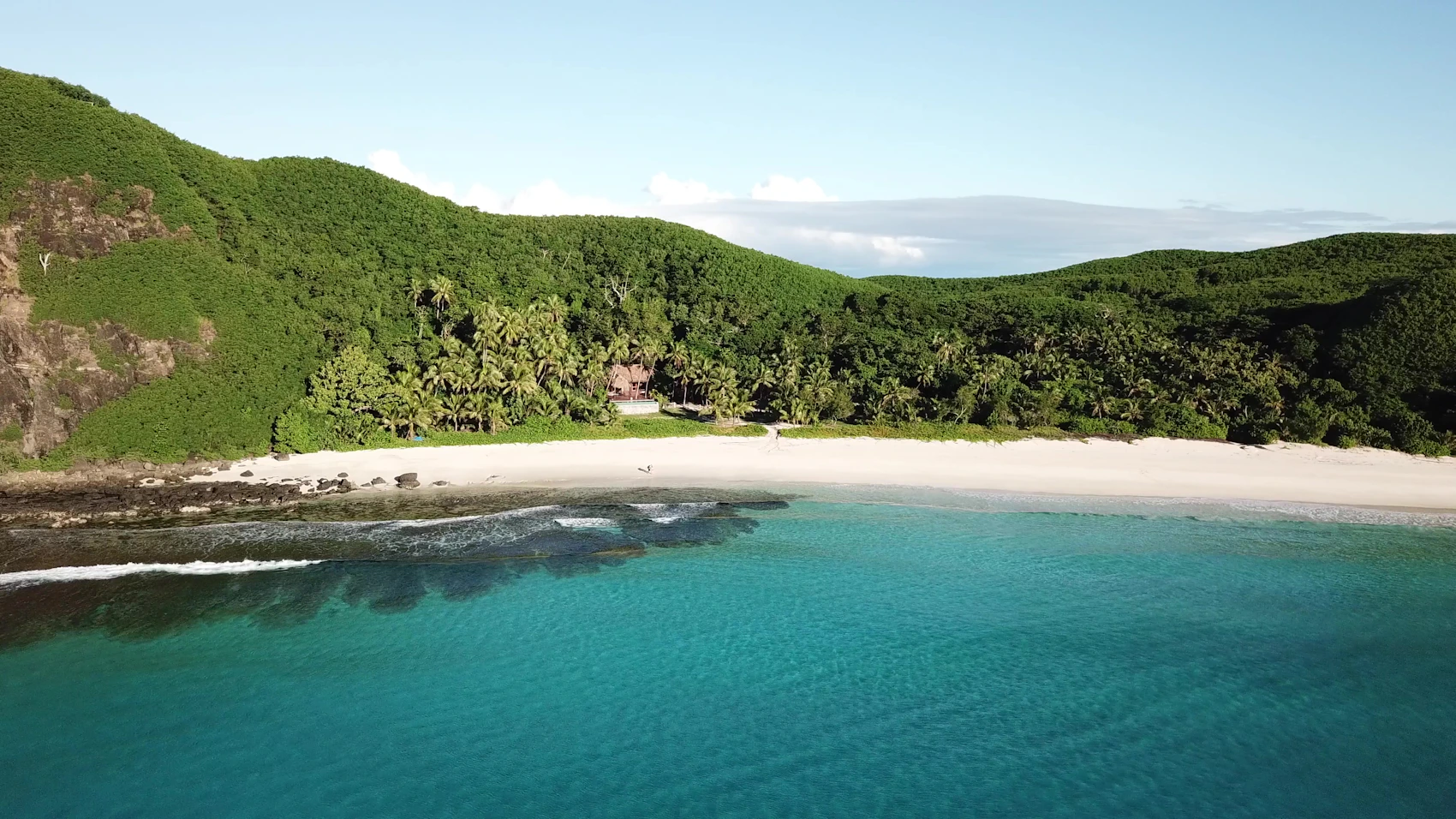 A forested shore and quiet beach on Yasawa Island in Fiji