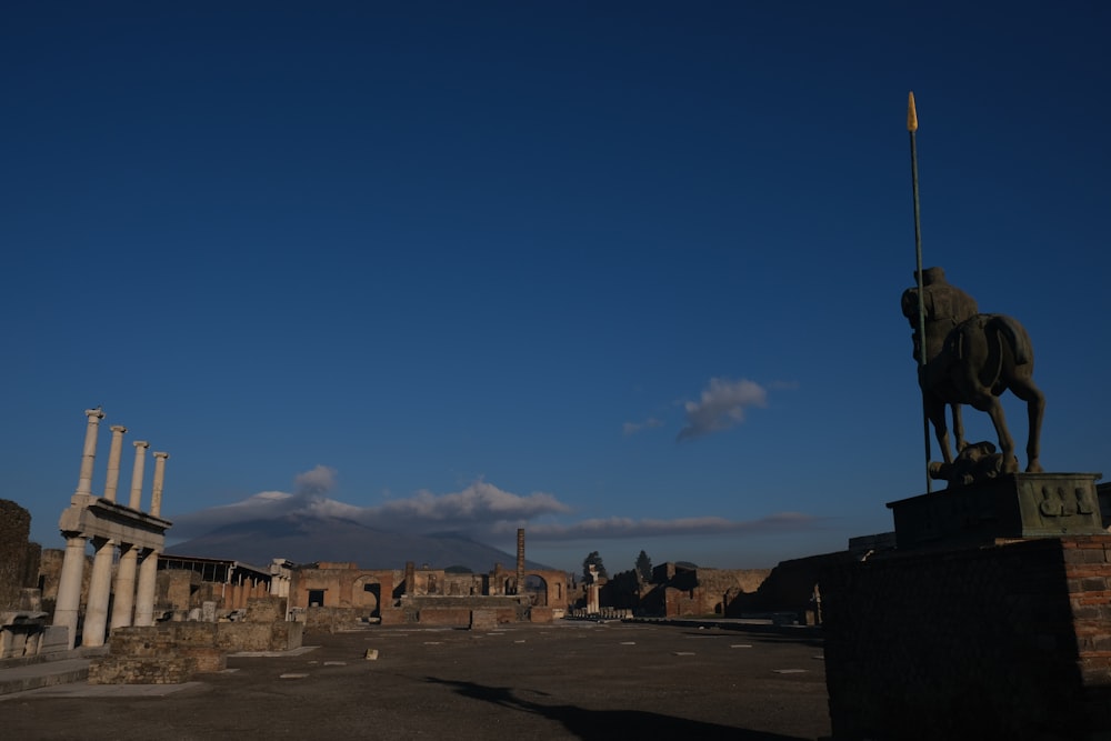 a statue of a horse on a pedestal in a city