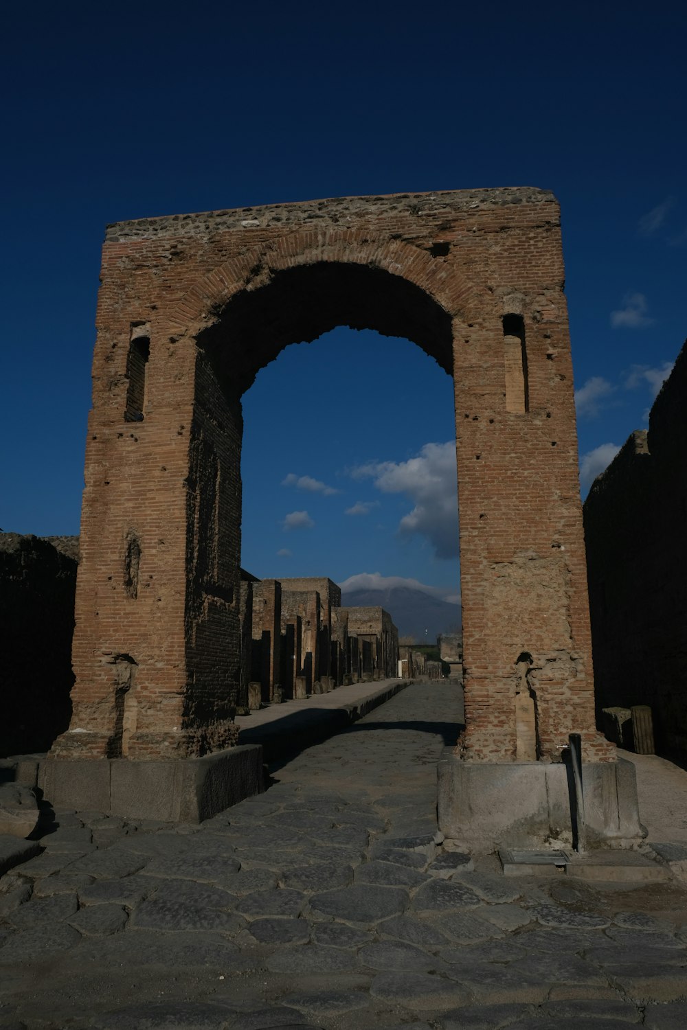 a stone archway with a blue sky