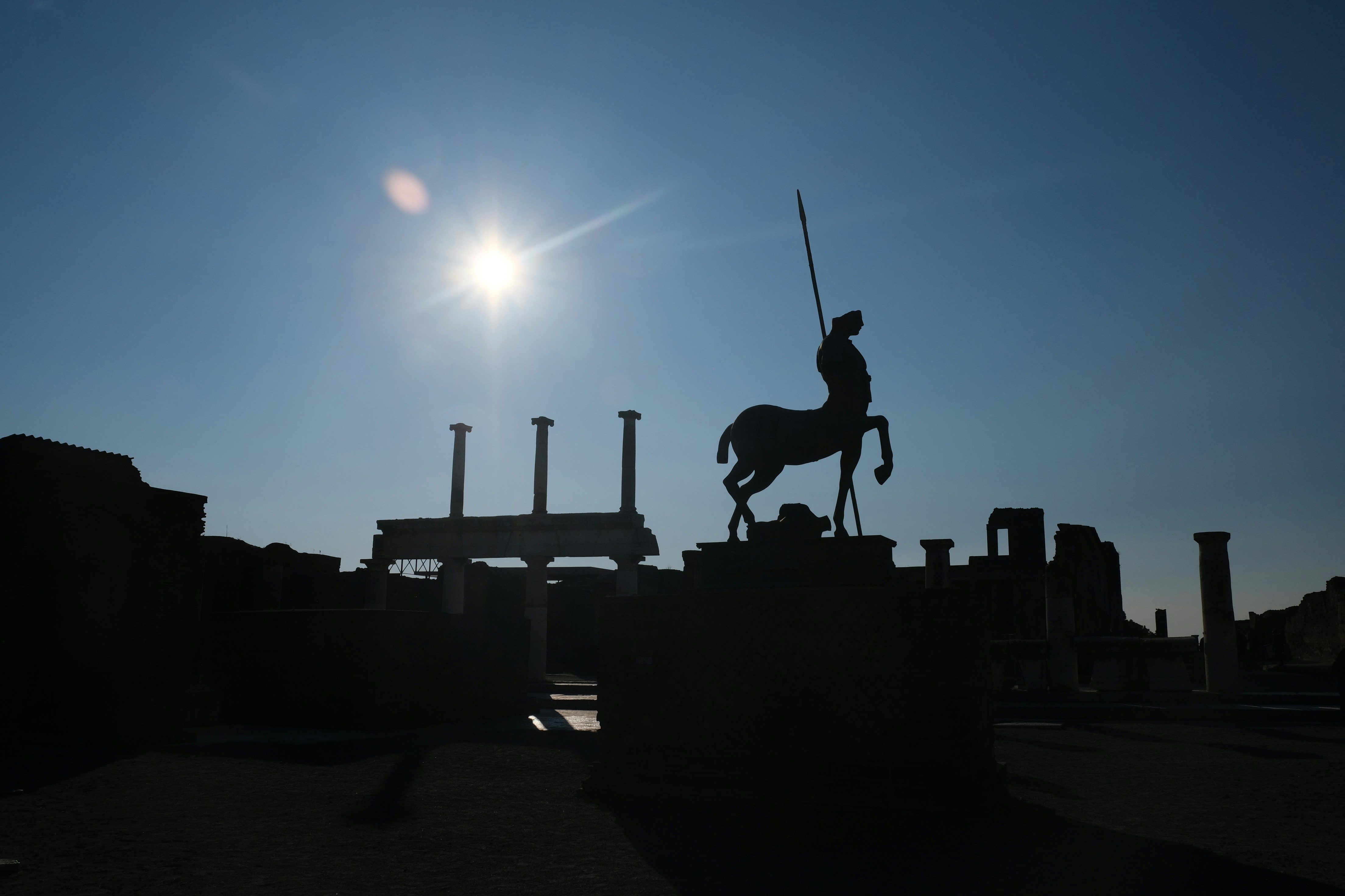 Silhouette of the centaur statue by Igor Mitoraj in the Forum at the ruins of Pompeii