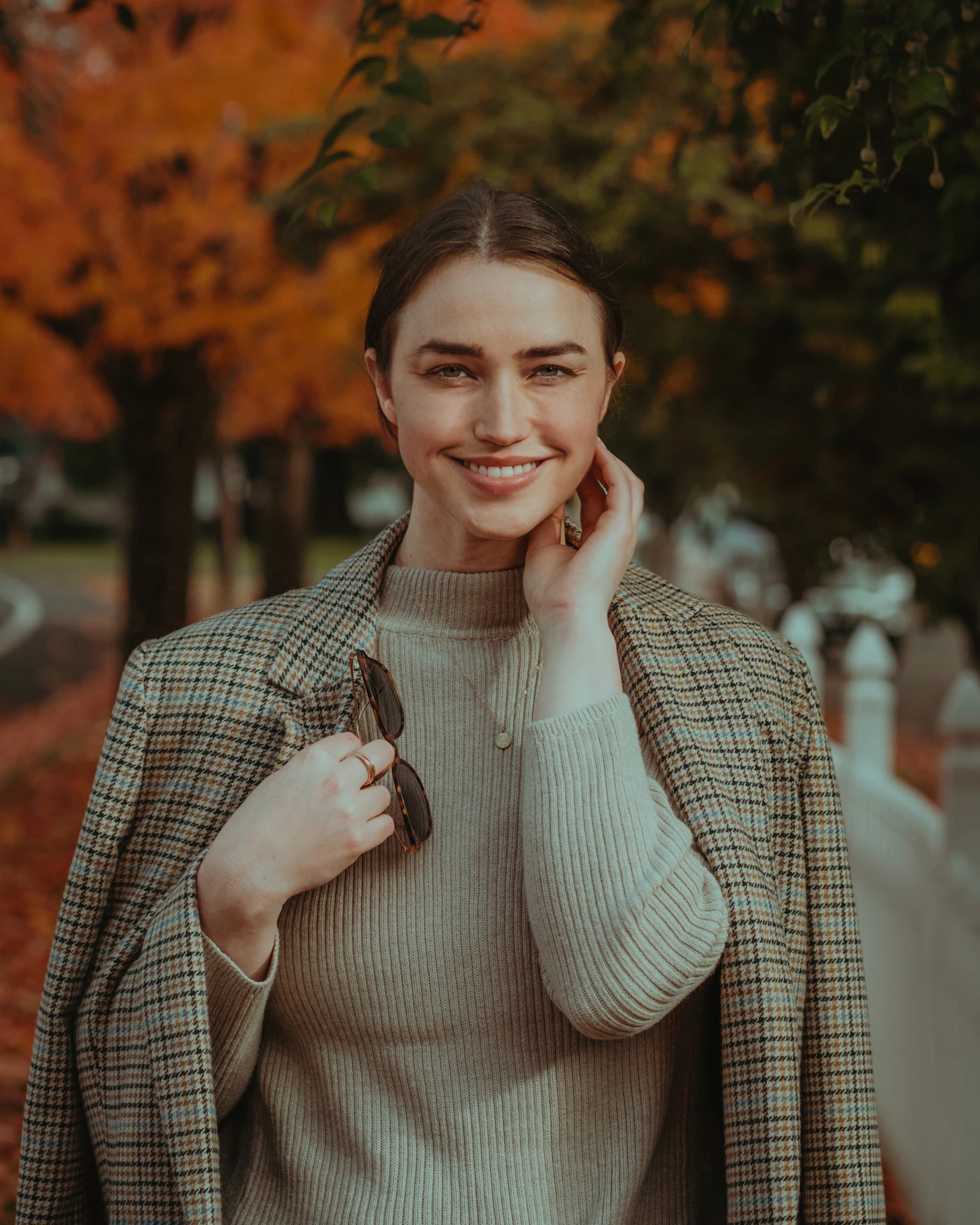 A person smiling while holding a phone