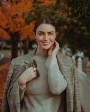 a person smiling while holding a phone