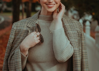 a person smiling while holding a phone