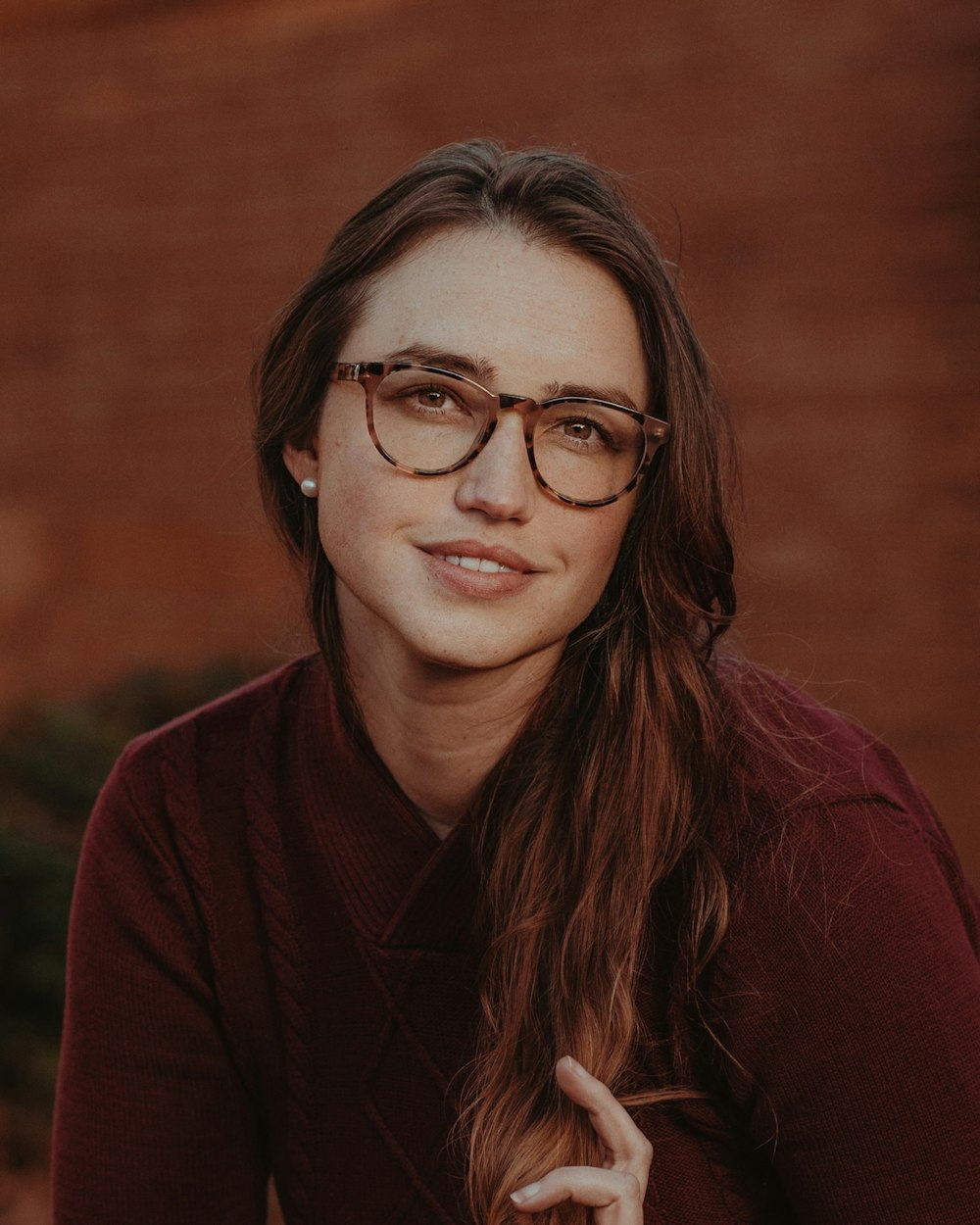 a person with long hair and glasses