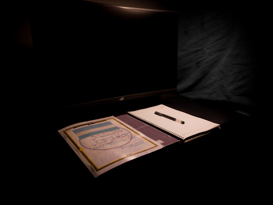 A professional office setting with a computer and notepad.