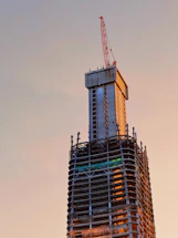 Close-up of a concrete slipform machine smoothly rising a building core at a construction site.