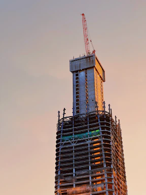 Close-up of a concrete slipform machine smoothly rising a building core at a construction site.