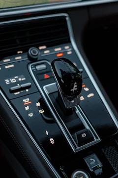 a car dashboard with a black steering wheel and a black screen