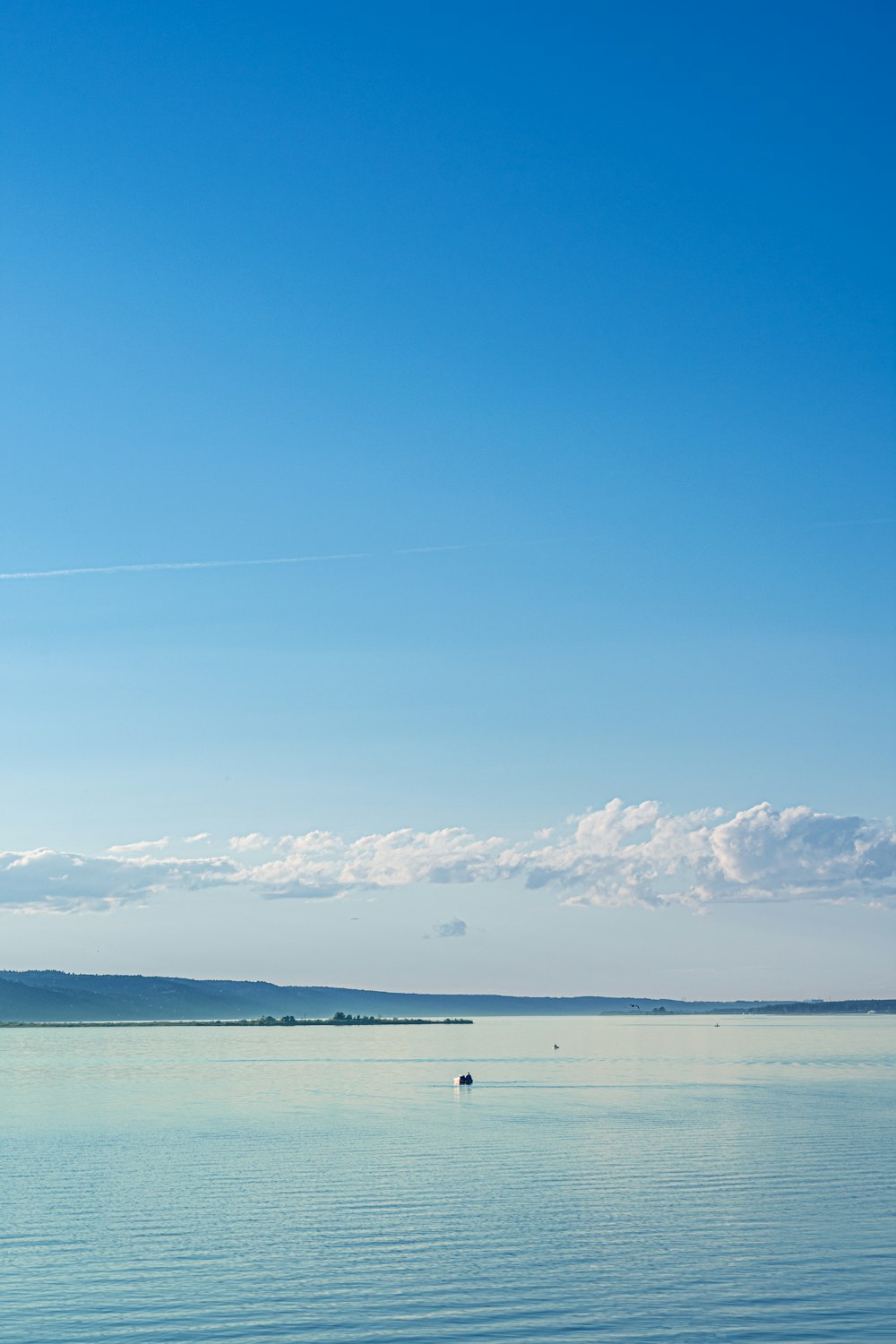 a body of water with a mountain in the background