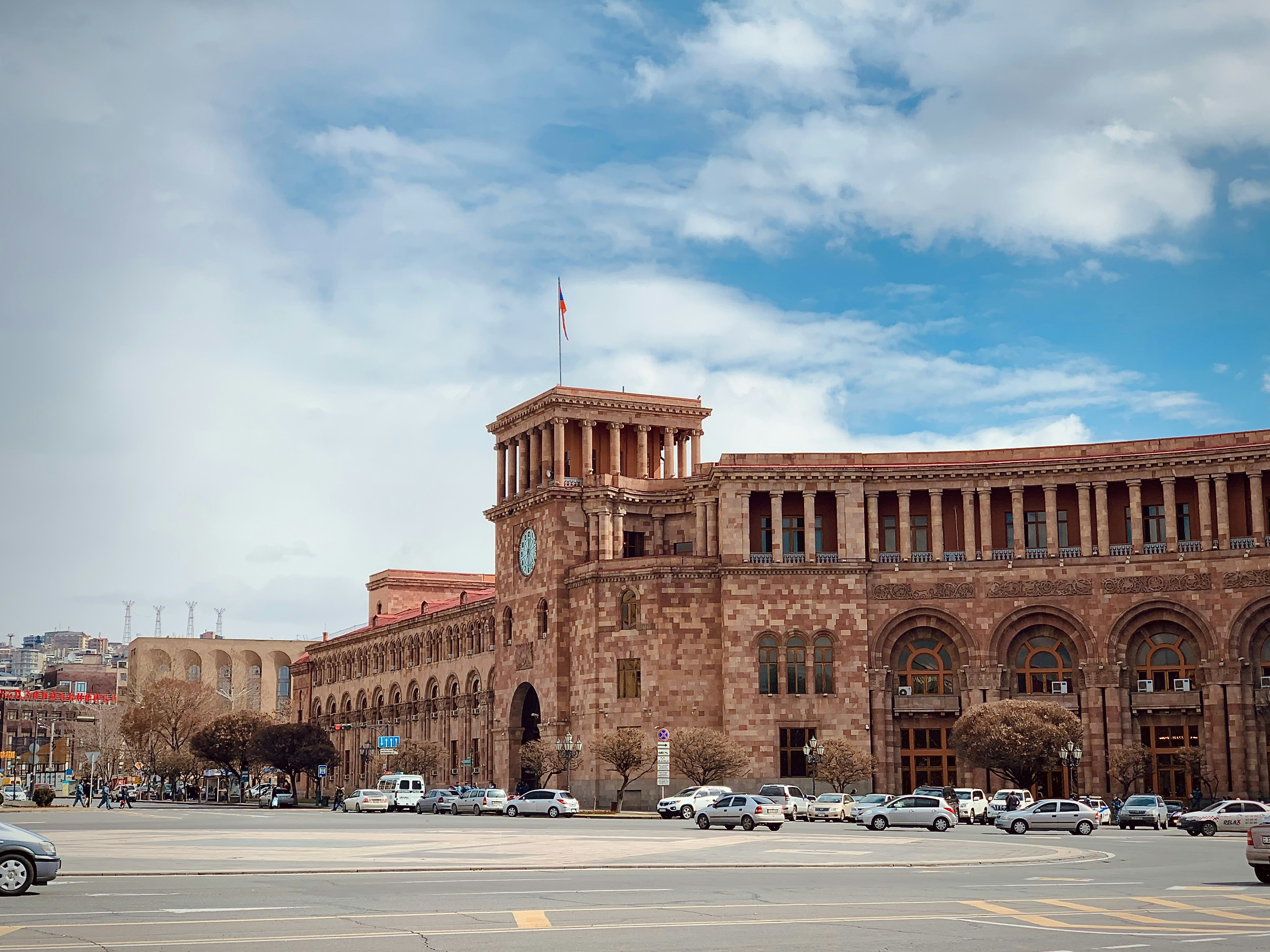 a large brick building with cars parked in front of it