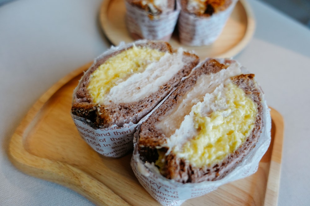 a couple of pastries on a wooden tray