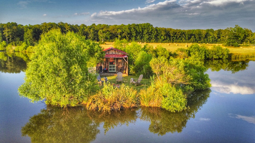 a house on a small island surrounded by trees and water