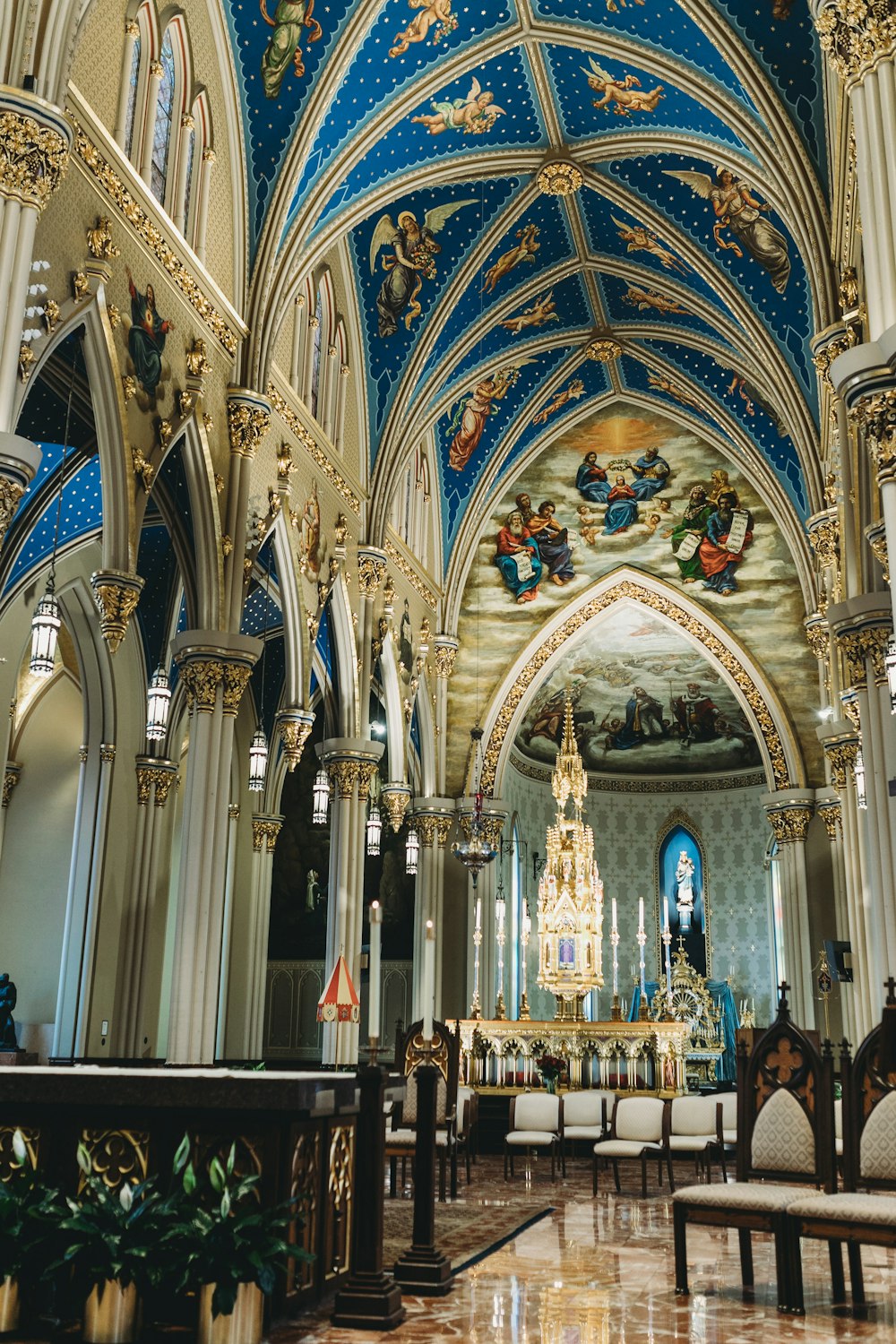 a large ornate room with a large stained glass window with Basilica of the Sacred Heart, Notre Dame in the background