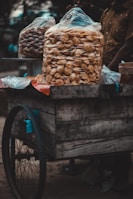 Close-up of a stylish cart serving gourmet snacks at a private party with warm lighting.
