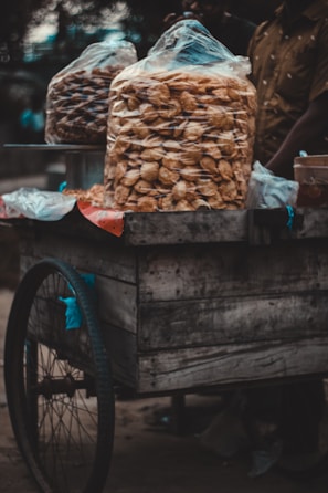 Close-up of a stylish cart serving gourmet snacks at a private party with warm lighting.