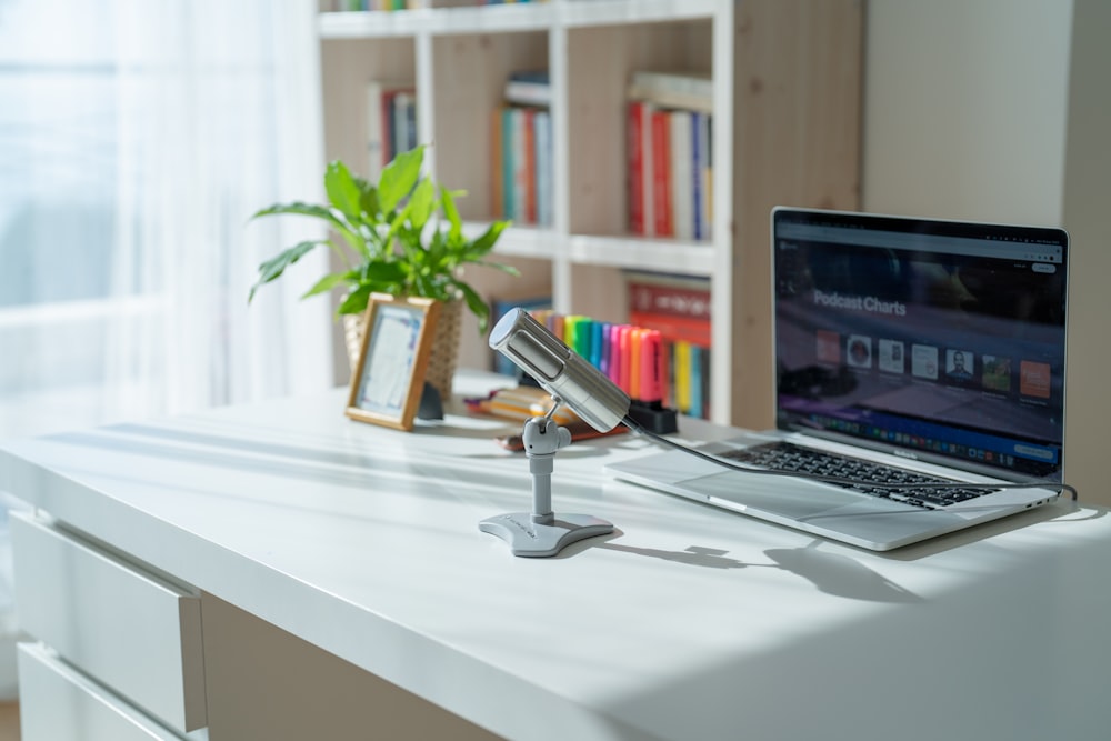 a laptop and a toy figurine on a table