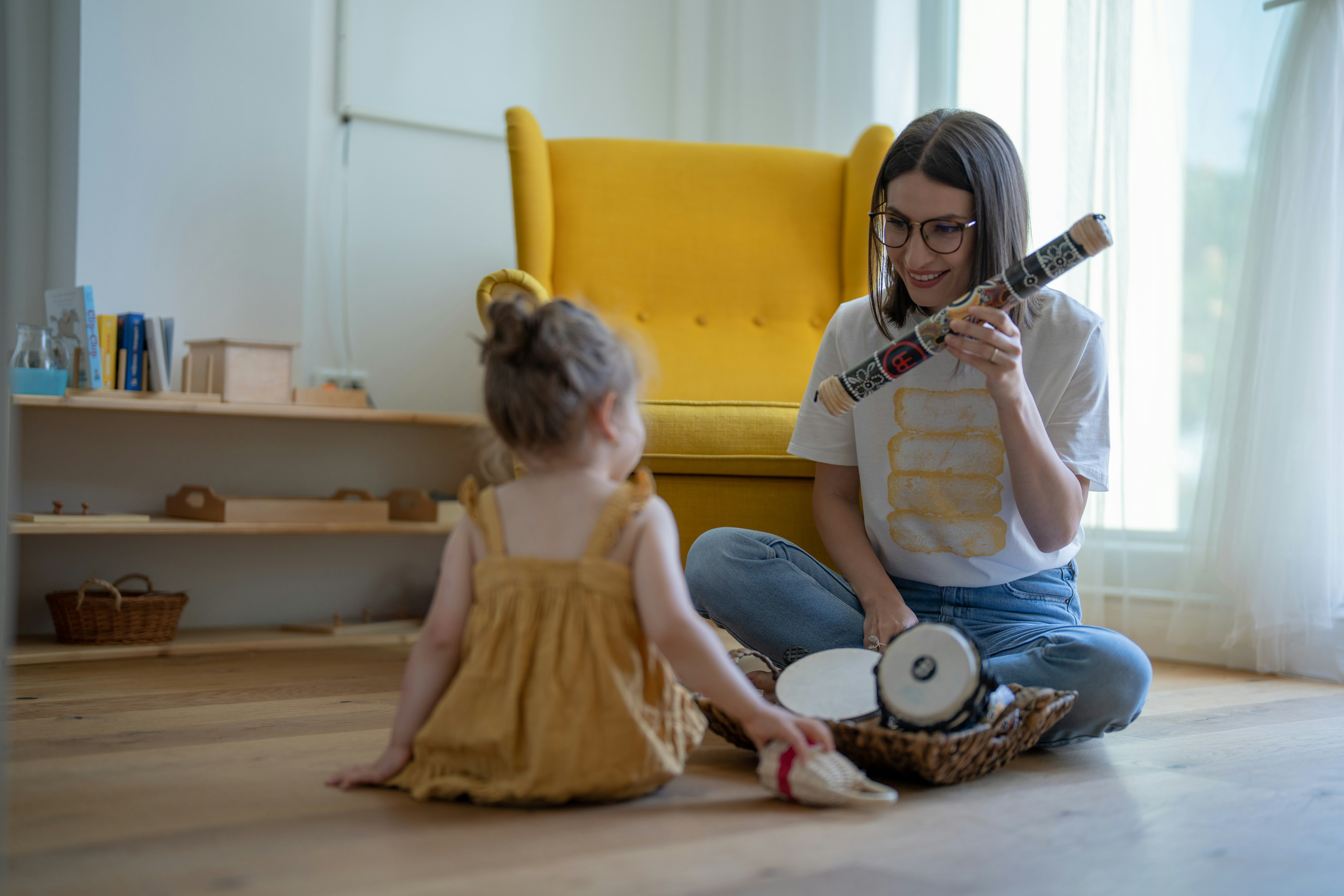 a woman and a child playing with a toy