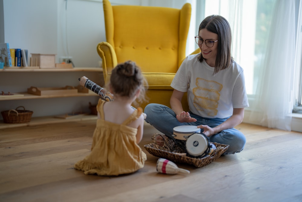 a person and a child sitting on the floor