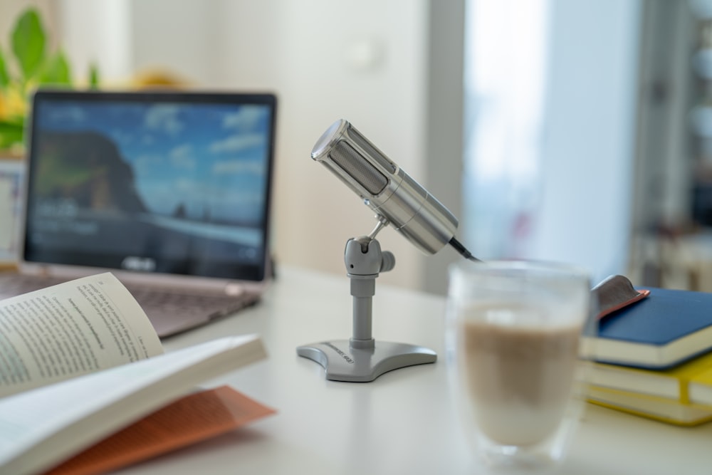 a desk with a microphone and a glass of water