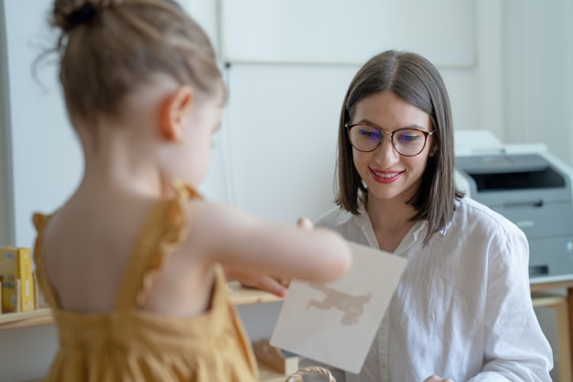 A consultant and parent smiling while discussing a student's progress report.