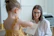A happy parent discussing progress with a friendly, professional teacher.