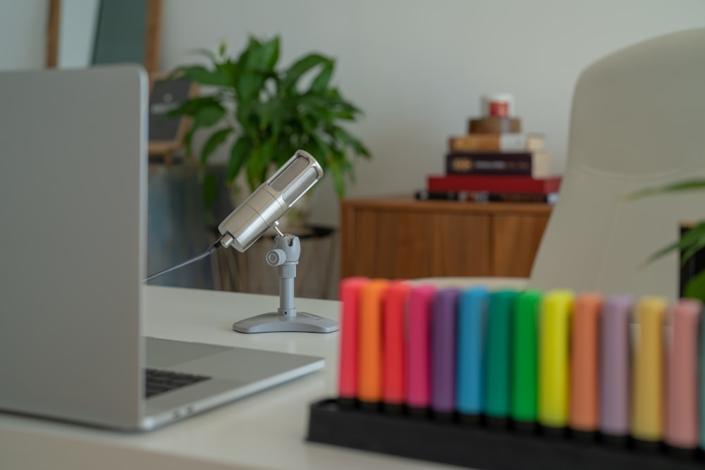 a desk with a laptop and books