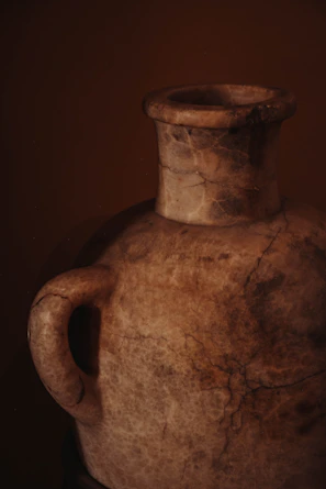Soft beige wooden urn with subtle engraved details in natural light