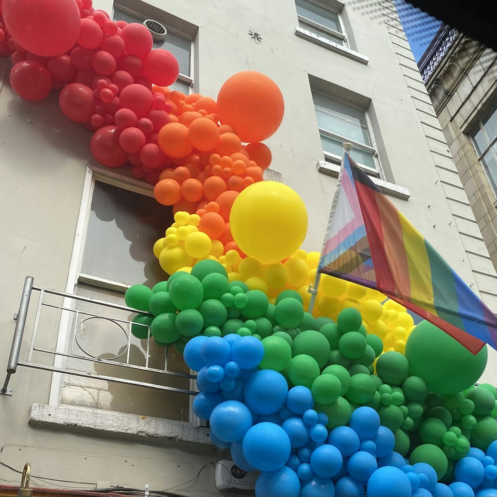 a building with balloons and a flag