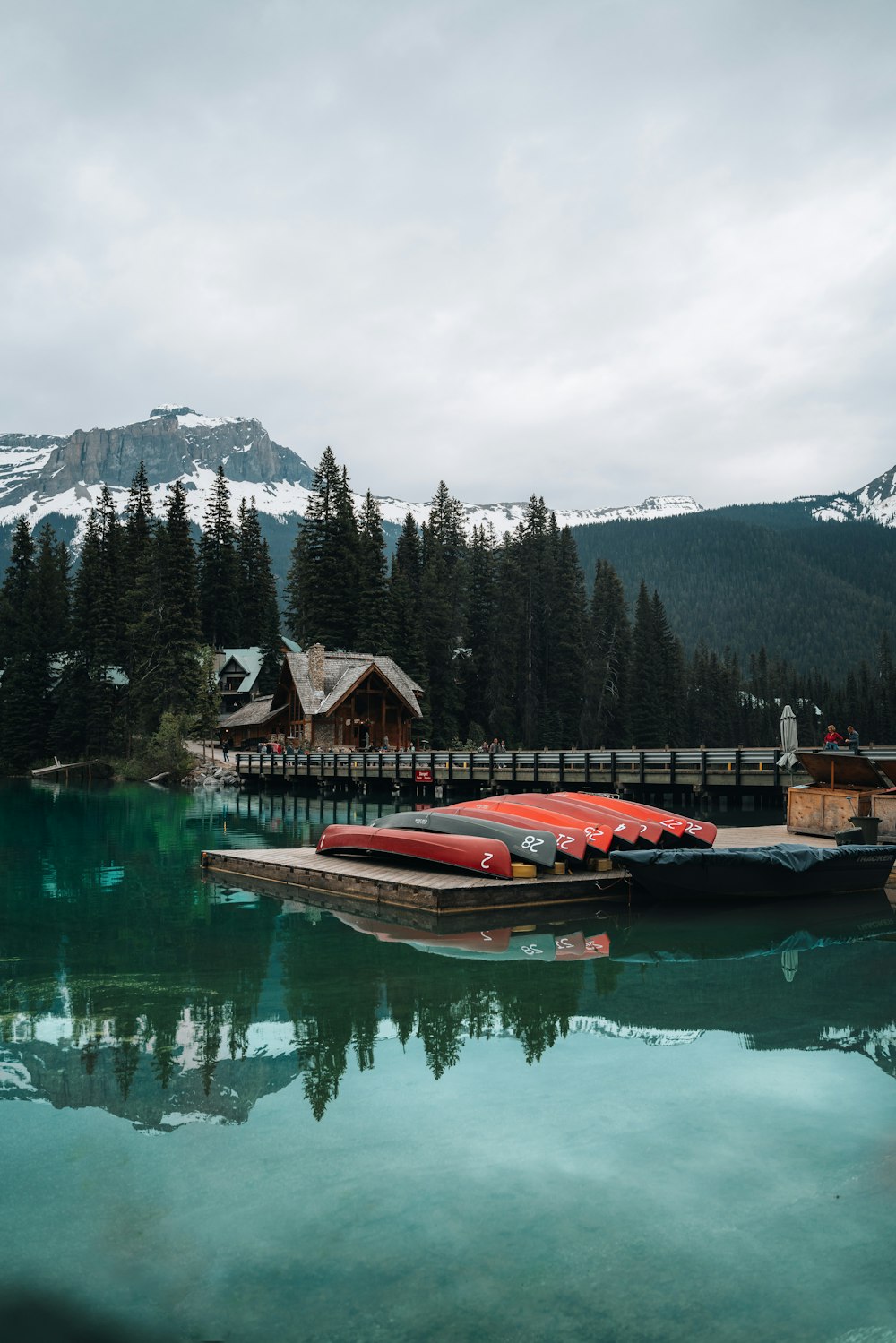 a dock with a boat on it by a house and trees