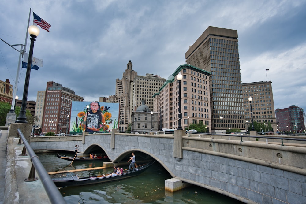 a bridge over a river with a city in the background