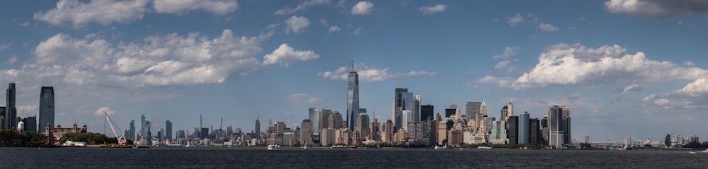 a city skyline with a body of water in the foreground