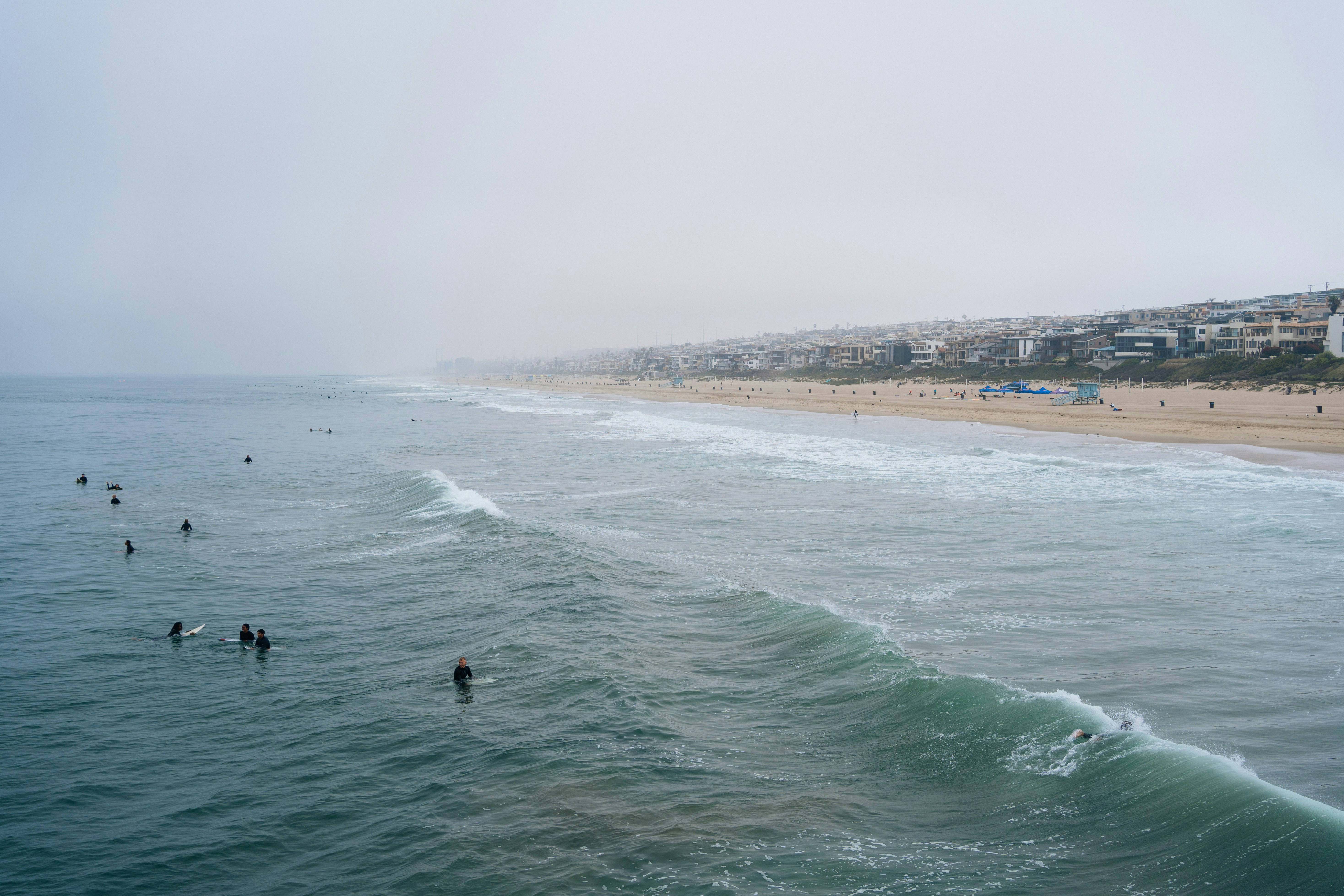 a group of people swimming in the ocean, 