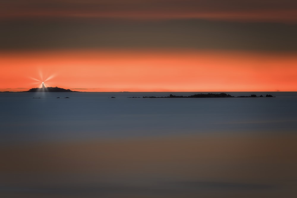 a sunset over a body of water