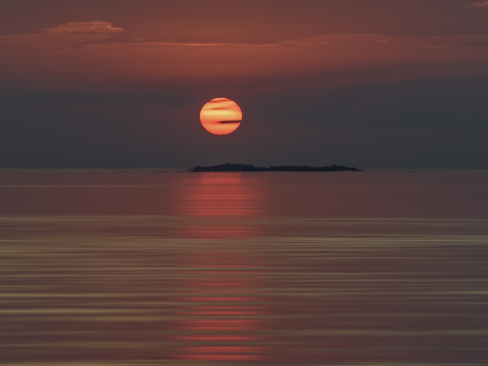 a sunset over a large body of water