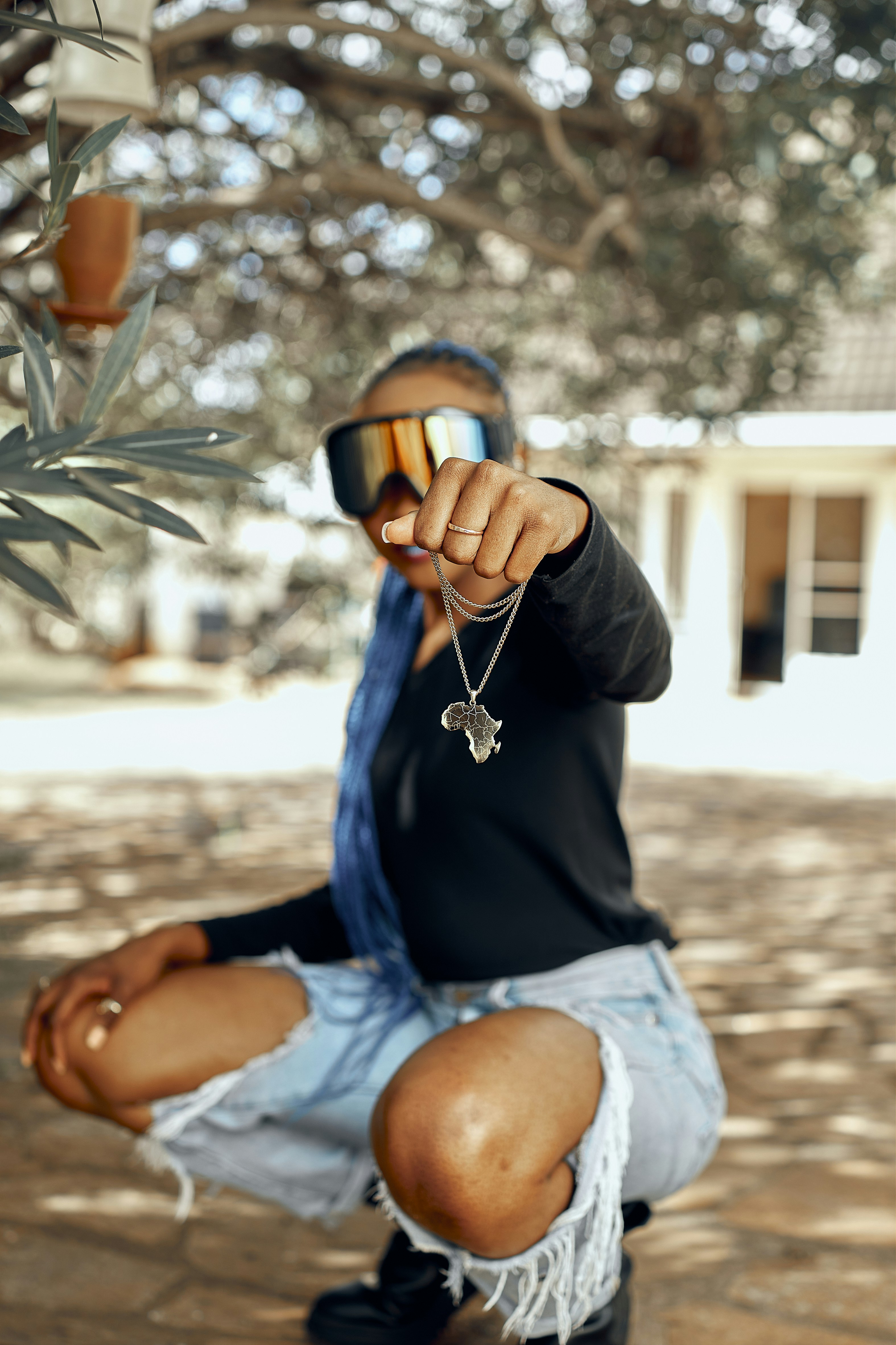 a person wearing a mask and sitting on a bench