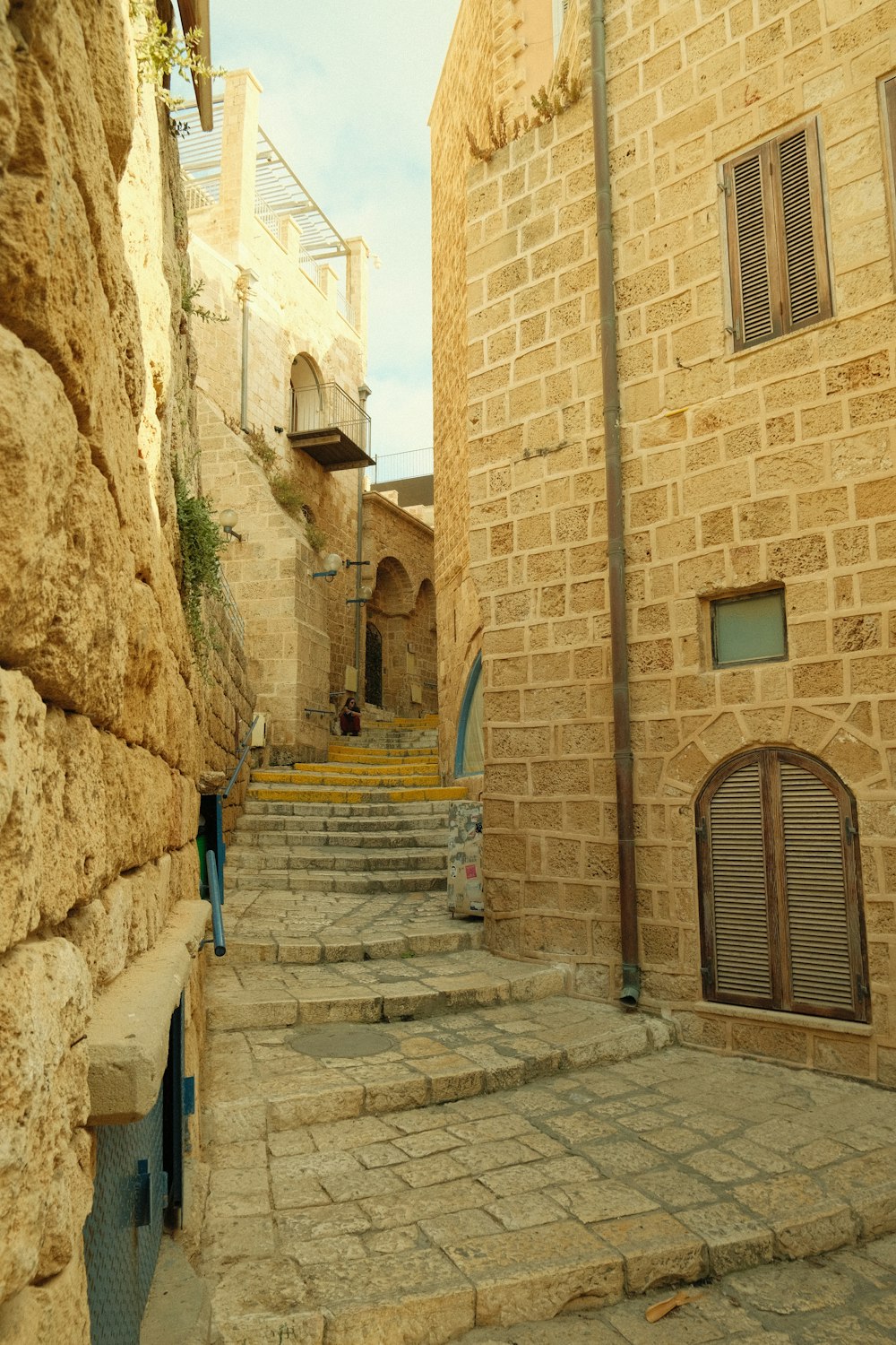 a stone street between two stone buildings