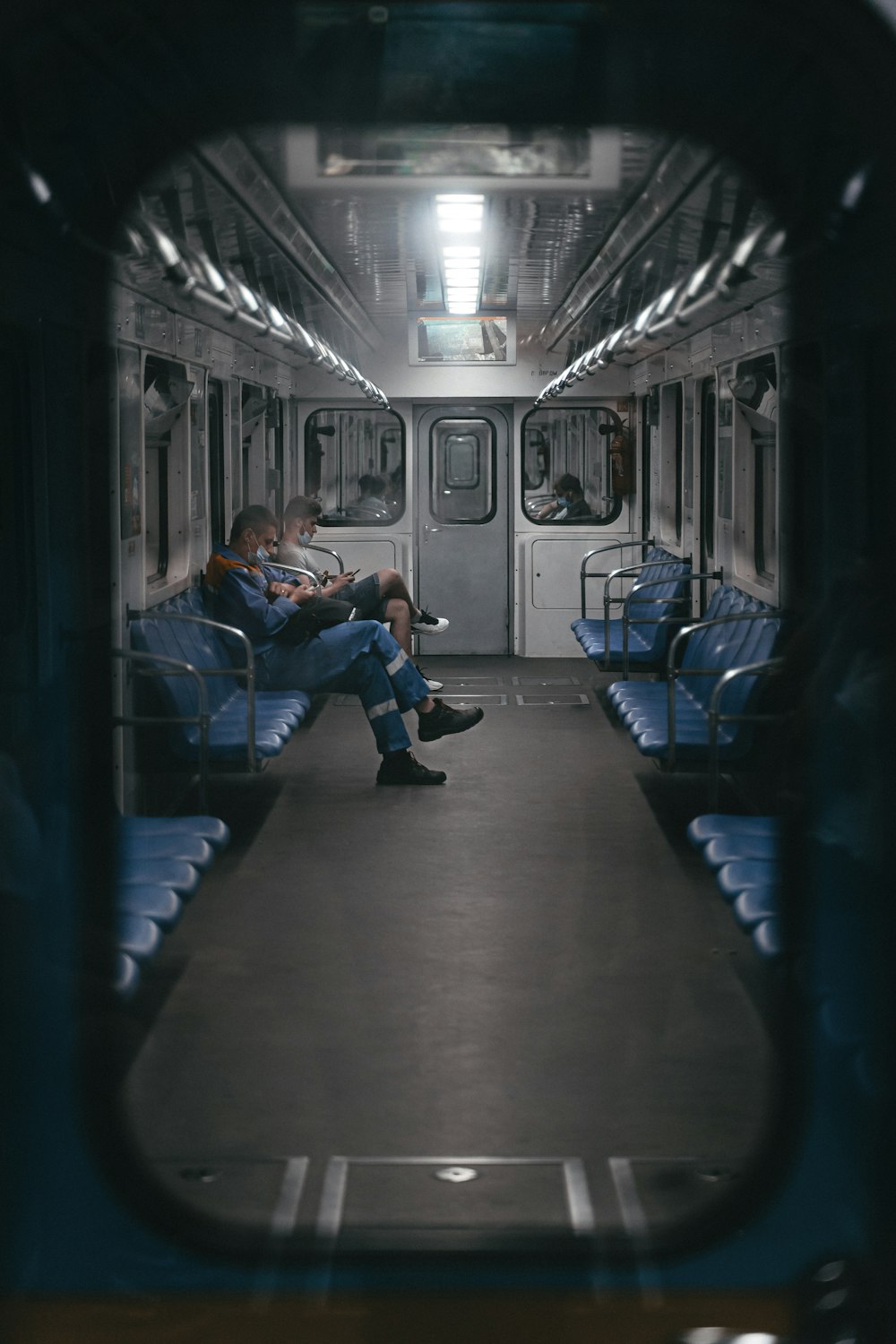 a couple of people sit on a train