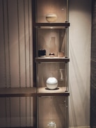 A stylish wooden shelf displaying various decorative items.