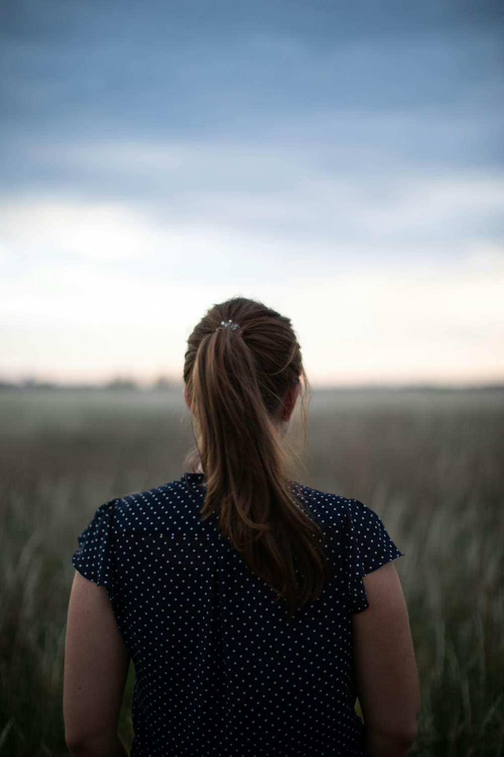 a woman sitting on a bench looking at the camera