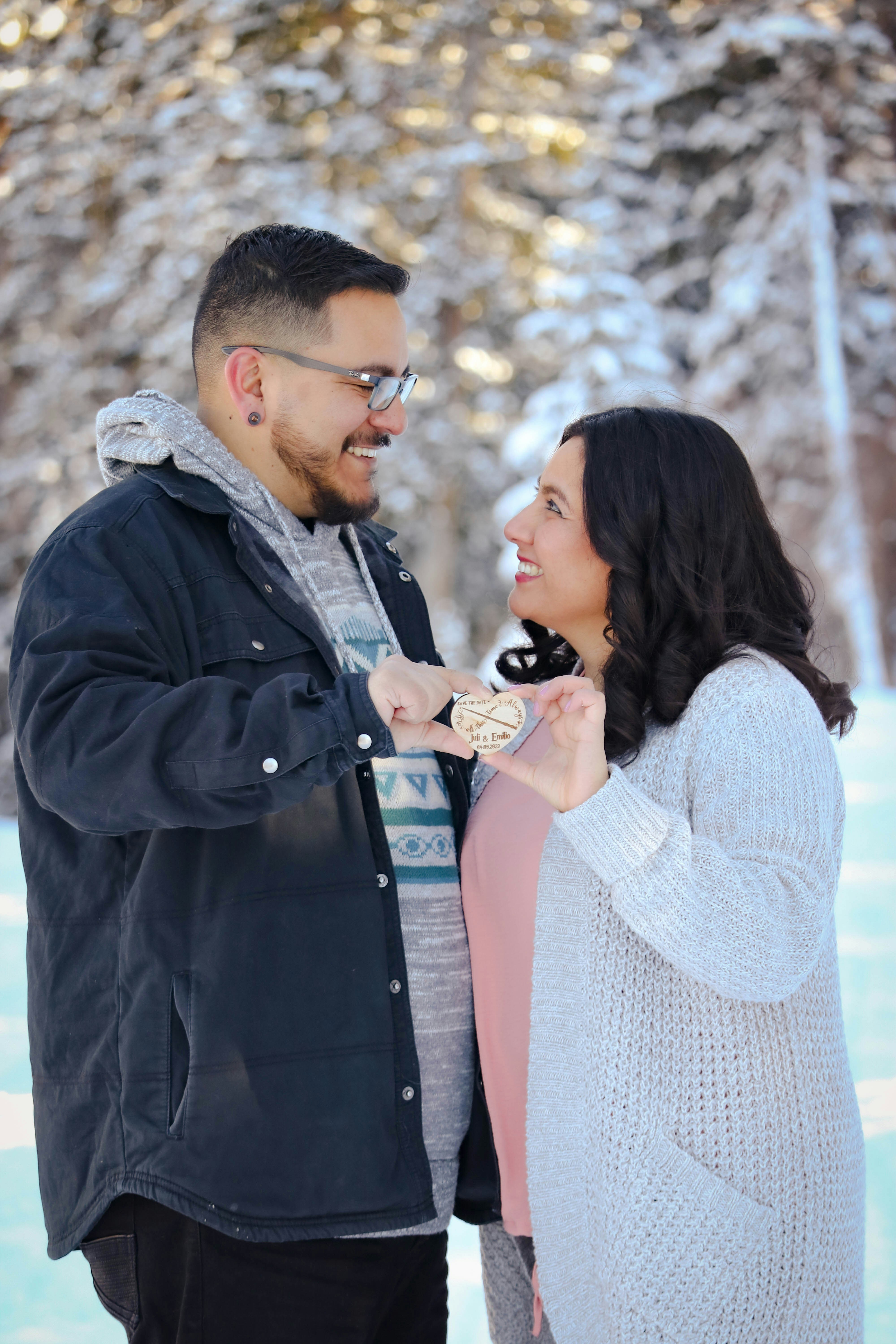a man and woman holding a small black object