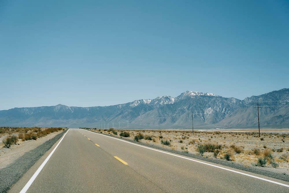 a road with mountains in the background