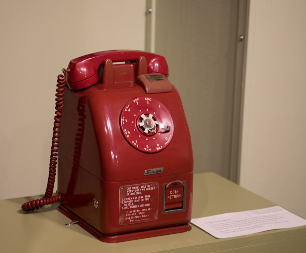 a red telephone on a table