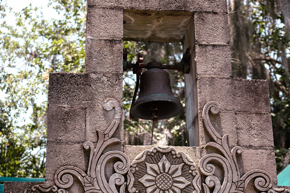 a bell on a stone building