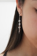 a woman's ear with a necklace