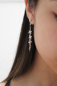 a woman's ear with a necklace