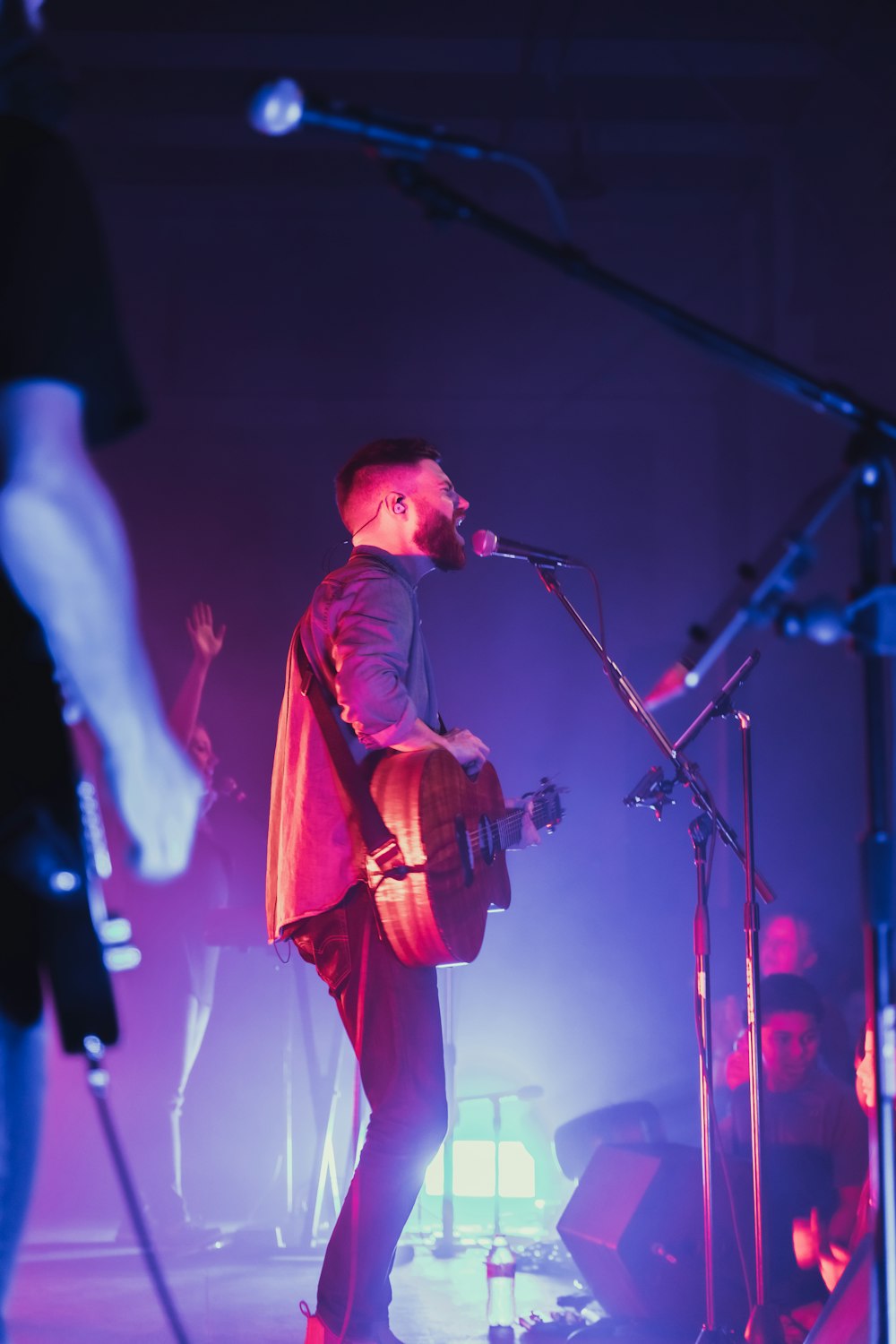 a person playing a guitar on a stage