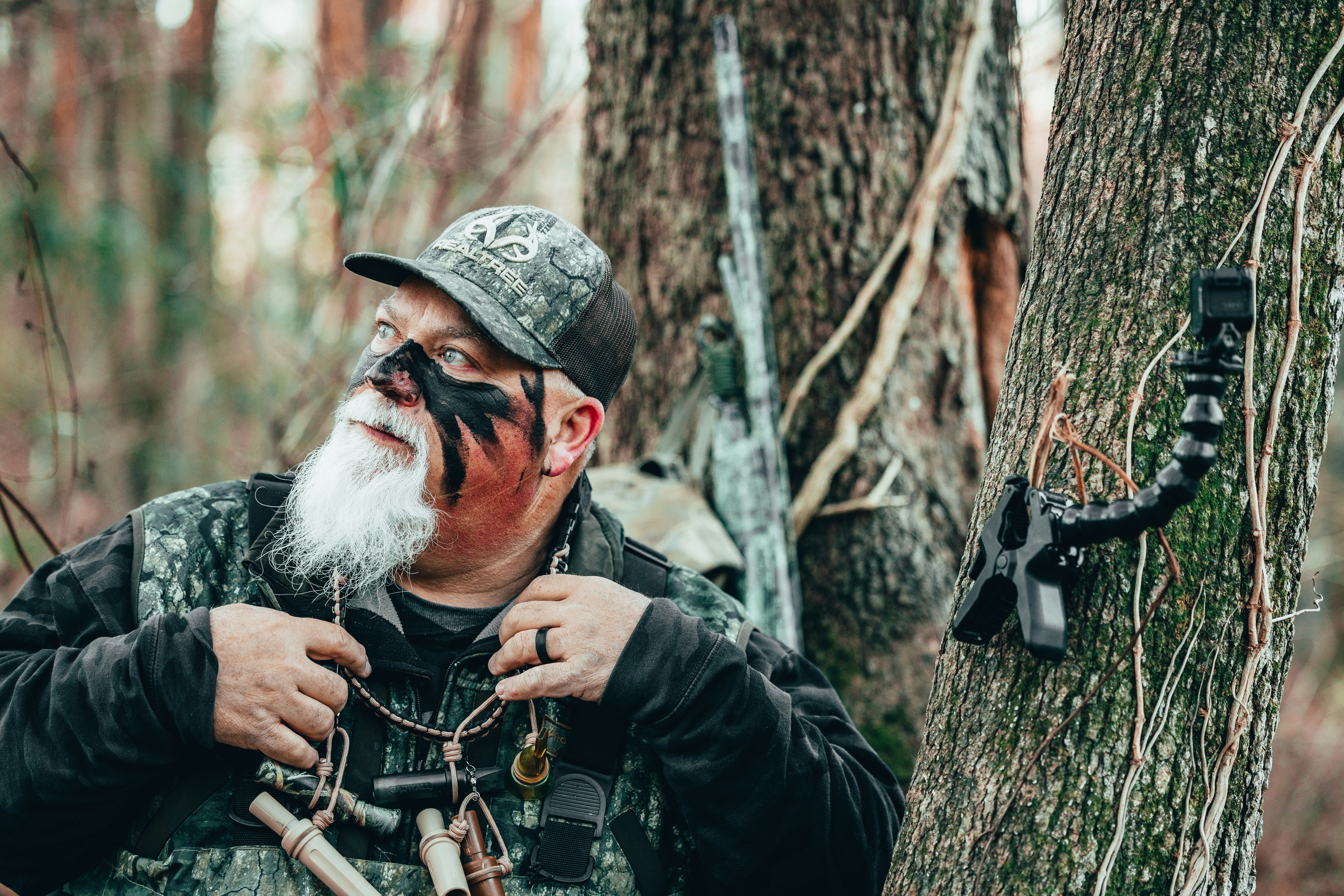 a man in a hat holding a gun