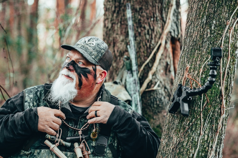 a man in a hat holding a gun