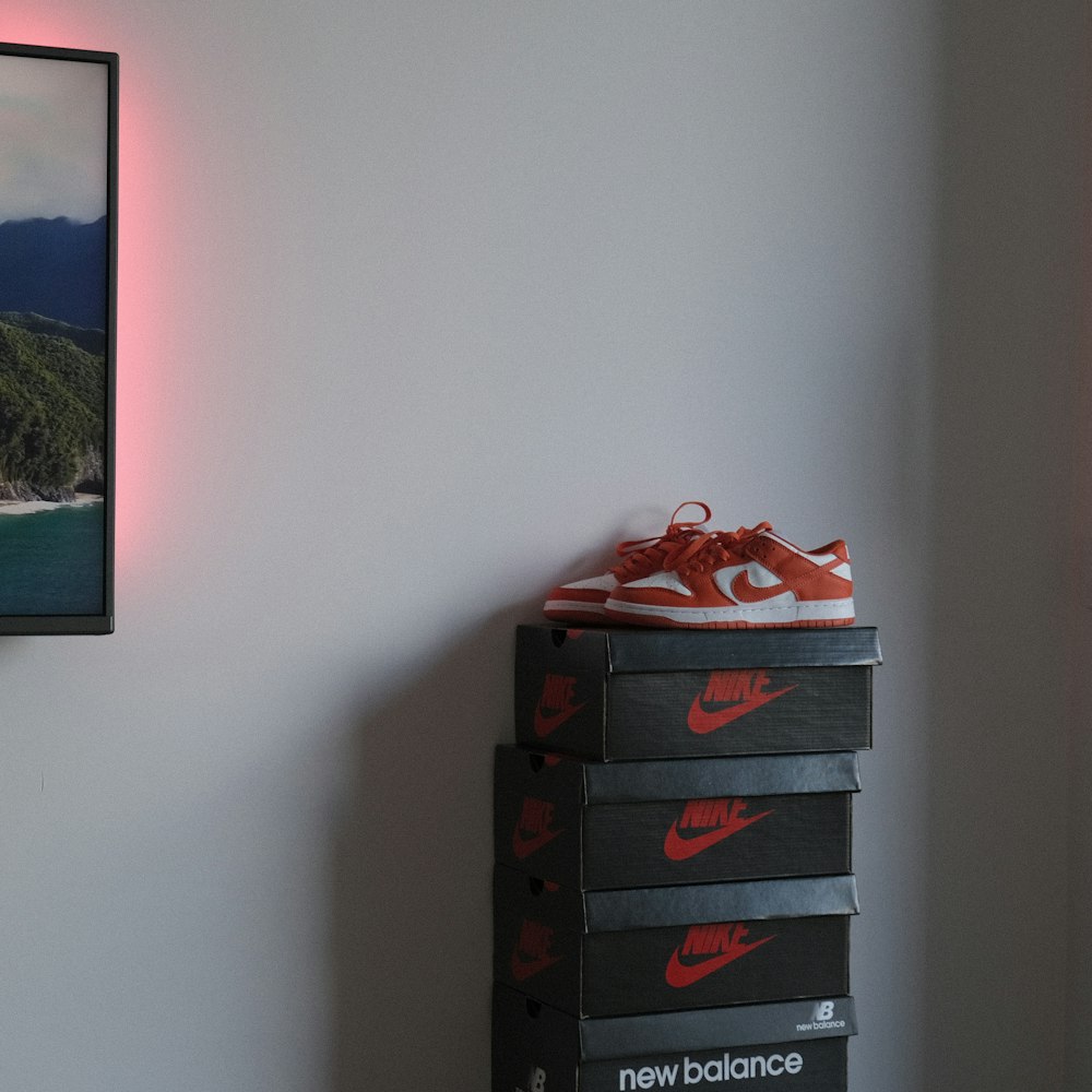 a pair of shoes on top of a stack of boxes